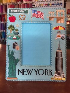 an embroidered picture frame with the new york skyline