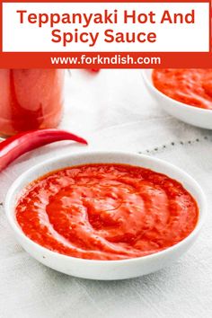 two white bowls filled with hot and spicy sauce next to a red chili pepper on the side