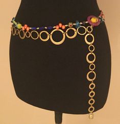 "Daydreamer Belt The inspiration for this beaded belt began with a recently acquired collection of vintage beads from Italy.  Many of these Venetian and Murano glass beads have silver, gold, and copper metallic treatments.  Others are confetti beads, and some are bumpy beads.   They are all so interesting.   For the pendant at the end of the chain I used a single gold lined Italian glass bead that was once an earring.  That bead is exquisite, and the glass has a \"sculpted\" swirl shape.   I com Interesting Belts, Hippie Belts, Belt Ideas, Belt Necklace, Boho Belt, Waist Jewelry, Boho Belts, Vintage Chain