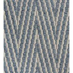 a blue and white rug with wavy lines on it