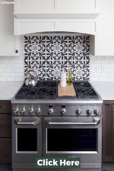 a stove top oven sitting inside of a kitchen next to a white cupboards and counter