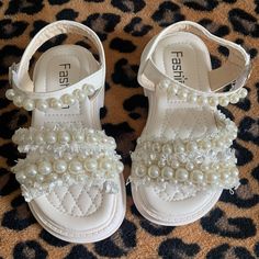 Never Worn. Size Shows A 25 But My Baby Wears A Toddler 8. White Sandals For Summer Playtime, Cute White Beach Sandals, Cute White Sandals For Spring, Adjustable White Sandals For Playtime, Cute Adjustable White Sandals, Pearl Sandals, Sandals Flip Flops, White Cream, Baby Wearing