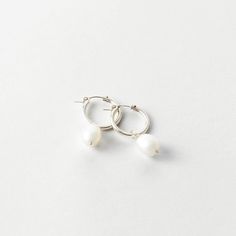 A classic hoop with a statement pearl. Dress them up or down. Classic White Huggie Pearl Earrings, Everyday Hoop Earrings With Pearl Pendant, Everyday Pearl Hoop Earrings With Pearl Pendant, Small Pearl Hoop Earrings For Everyday, Everyday Hoop Earrings With Pearl Charm In Sterling Silver, Minimalist Small Hoop Pearl Drop Earrings, Everyday Small Pearl Hoop Earrings, Classic White Hoop Earrings With Pearl Charm, Small Hoop Pearl Earrings For Everyday