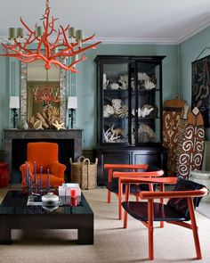 a living room filled with furniture and a chandelier hanging over the top of it