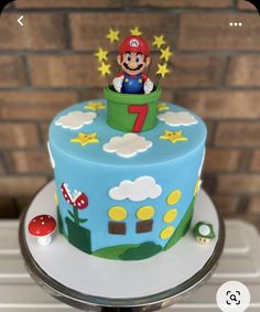 a blue cake with a mario on top