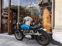 a motorcycle parked in front of a store window