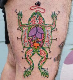 a man with a frog tattoo on his leg