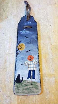 this is an image of a door hanger with a painted scarecrow on it