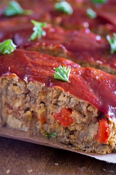 the meatloaf is covered with sauce and garnished with parsley