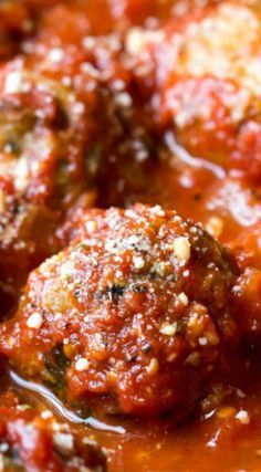 meatballs covered in marinara sauce and parmesan sprinkled on top