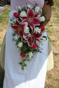 a woman in a white dress holding a bouquet of flowers