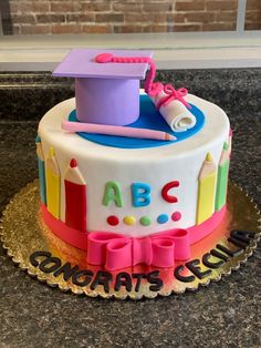 a cake decorated to look like a graduation cap and diploma