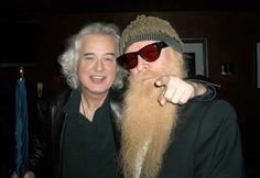 two men with long white hair and beards pose for the camera while wearing sunglasses