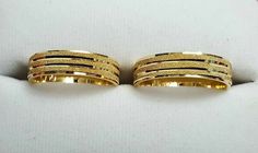 two gold rings sitting on top of each other