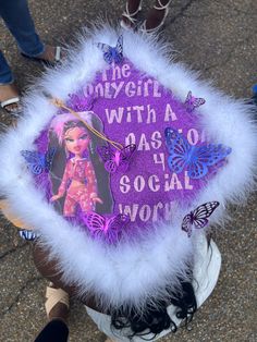 A Masters Social Work Graduation Cap A glitter light purple graduation cap with white faux fur trim. A picture of the Bratz doll Yasmin in a pink two piece is on one side and the other side is the slogan for Bratz edited to say The Only Girl With a Passion for Social Work. Bratz Graduation Photoshoot, Social Work Grad Cap, Bratz Graduation Cap, Social Work Graduation Pictures, Social Work Cap Ideas Graduation, Masters Grad Cap