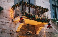 a balcony decorated with christmas lights and bells