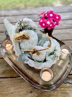 some flowers and candles are on a tray