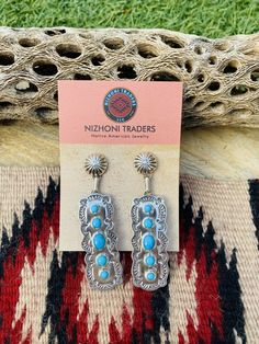 New without tags BRAND : Nizhoni Traders LLC ETHNIC & REGIONAL STYLE : Native American JEWELRY TYPE : Earrings METAL : Sterling Silver TRIBAL AFFILIATION : Navajo MAIN STONE : Turquoise Lovely Navajo Turquoise and Sterling Silver dangle earrings. Measure 2 7/8 inches long and 3/4 of an inch wide. Great pair of earrings! Stamped Sterling and signed by the artist. Thank you for checking out my store. Please contact me with any questions. Exported By exportyourstore.com Southwestern Style Blue Pierced Earrings, Southwestern Style Blue Earrings For Pierced Ears, Southwestern Blue Earrings For Pierced Ears, Southwestern Blue Earrings For Gift, Blue Southwestern Style Earrings For Gift, Southwestern Style Blue Drop Earrings, Southwestern Blue Drop Earrings, Navajo Turquoise, Earrings Metal