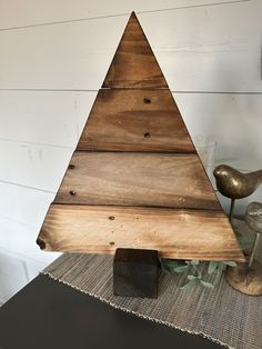 a wooden christmas tree sitting on top of a table