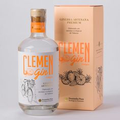 a bottle of clemen girl gin is next to a cardboard box on a white surface