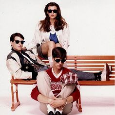 two people sitting on a bench with one person wearing sunglasses