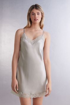 Silk slip with adjustable, skinny straps and lace embellishment on the V-neck and hem. The model is 5'9 and is wearing size S. 
 
 Silk, the most noble and finest of natural fibers, is also one of the most durable. Enveloping and keeping you warm in winter, but light to wear in summer, silk allows your skin to breathe. Our vast range of 100% silk designs offer the perfect solution for everyone who prefers a sophisticated look without sacrificing comfort. Sublime noble fibers for day or night. Elegant Lace Trim Cami Slip Dress, Elegant Cami Slip Dress With Lace Trim, Elegant Spring Sleep Camisole, Elegant Camisole For Spring Loungewear, Elegant Sleep Camisole With Delicate Lace, Elegant Lace Sleep Camisole, Elegant Lace Camisole For Sleep, Elegant Delicate Lace Sleep Camisole, Elegant Camisole With Delicate Lace And Spaghetti Straps