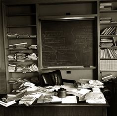 a desk with lots of books and papers on it