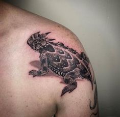 a man with a tattoo on his shoulder has a turtle in it's shell