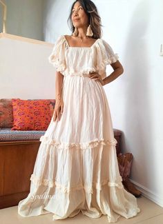 Bohemian off shoulder wedding dress . Double Ruffle and unfinished hem. Elastic neckline and waist. Can be worn as cover or off shoulders and one side shoulders. 100% cotton with lined. 2 pockets in the front. Color Off White. Measurements: The model is 5'5 Bust 30 up to 42 inches. Hip Free. Length 56 inches. CARE: Machine wash cold. Off-shoulder Ruffled Maxi Dress For Wedding, Bohemian Ruffled Dress For Beach Wedding, Flowy Boho Dress For Beach Wedding, Cream Bohemian Dress For Beach Wedding, Flowy Off-shoulder Maxi Dress For Wedding, Beige Boho Wedding Dress For Summer, Beige Boho Summer Wedding Dress, Summer Beige Boho Wedding Dress, Beige Off-shoulder Bohemian Dress