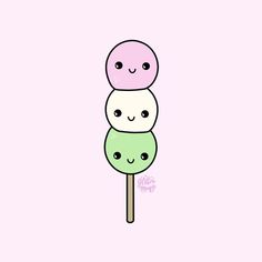 two lollipops with faces drawn on them, one is green and the other is pink