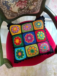 a crocheted pillow sitting on top of a chair