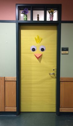 a yellow door decorated to look like a chicken