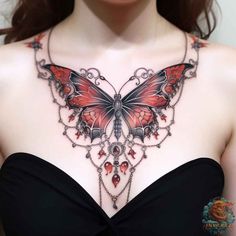 a woman's chest with a butterfly tattoo on the top and chains attached to it