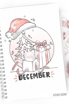 a notebook with a drawing of a santa hat and presents on it, next to some christmas decorations