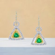 These earrings are gorgeous and stunning! Two trillion cut tsavorite garnets are set with round brilliant-cut diamonds and bright yellow sapphires. The garnets are a beautiful, brilliant grass-green color. The yellow sapphires and diamonds compliment and contrast with the green garnets and add even more sparkle. They are made of 18k white and yellow gold by our Master Jewelers in Los Angeles. Tsavorite garnets, 4.00 millimeters, .67 carat total118 round brilliant cut diamonds, .95 carat total36 round cut yellow sapphires, .18 carat total Luxury Green Diamond Earrings With Accents, Green Diamond Earrings Fine Jewelry, Green Diamond Earrings In Fine Jewelry Style, Green Diamond Drop Earrings With Accents, Green Pave Setting Fine Earrings, Green Gemstone Diamond Earrings, Green Brilliant Cut Drop Earrings, Green Diamond Earrings With Gemstone Accents, Gold Triangle