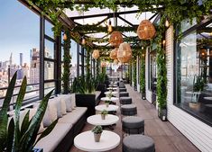 an outdoor seating area with potted plants on the roof