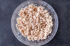 a bowl filled with food sitting on top of a table next to a black surface