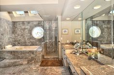 a large bathroom with two sinks and a walk in shower