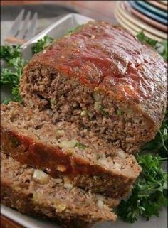 meatloaf on a plate with parsley and ketchup