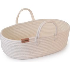 a white baby bassinet with handles and rope on the bottom, in front of a white background