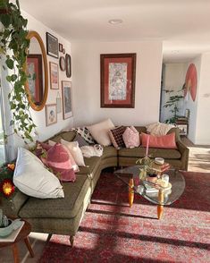 a living room filled with furniture and lots of pillows on top of it's couches