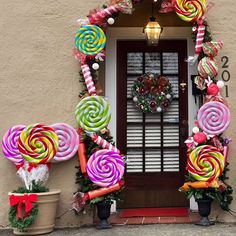 the front door is decorated with candy canes