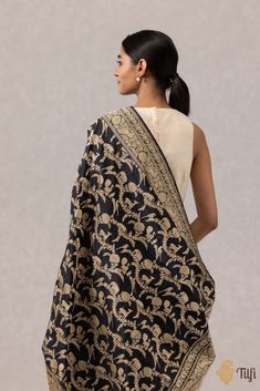 "In a\u00a0regal palette, exuding charms of a bygone era, this is an unforgettable piece of handwoven luxury. Crafted to perfection in the finest Kadhua weave and\u00a0gold zari, this\u00a0exquisite\u00a0drape\u00a0is adorned with an intricate and opulent jangla pattern.\n\u00a0\n\n\n\n Color\u00a0-\u00a0A\u00a0classic\u00a0shade of\u00a0Black\n\n\n Technique\u00a0-\u00a0Classic handwoven Banarasi art passed down through generations and an enduring Kadwa weave. The elaborate and laborious Kadwa (Kadhua) technique involves hand-weaving each motif separately. It takes longer on the handloom, but makes a more robust pattern which stands out on the fabric.\u00a0\n\n\n Fabric\u00a0- Soft as butter, pure Katan silk\n\n Speciality\u00a0- A luxurious colour, an opulent zari jaal and incredibly det Luxury Banarasi Silk Fabric Handloom, Luxury Handloom Banarasi Silk Fabric, Black Pure, Katan Silk, Bygone Era, Hand Weaving, Take That, Charms, Silk