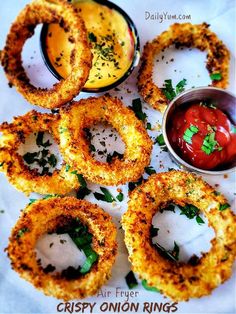 crispy onion rings with ketchup, mustard and tomato sauce on the side