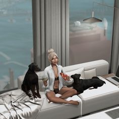 a woman sitting on a couch with two dogs