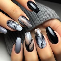 Nails with a smoky marble effect, created using shades of gray, black, and white. The marbled pattern is sophisticated and mysterious, giving the nails a sexy, high-fashion look. A glossy or matte top coat can be used to finish the design. Grey And White Gel Nails, Matt White Nails With Design, Black White Gray Silver Nails, Grey Gothic Nails, Black And Silver Marble Nails, Matte Marble Nail Designs, Gel Polish Nail Designs Black, Gray And Black Nails Ideas, Smokey Marble Nails