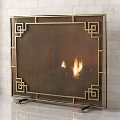 a fire place in the middle of a room with white tiles on the walls and floor