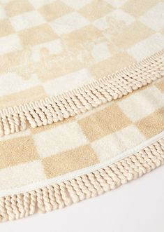 two pieces of beige and white checkered rugs on top of eachother