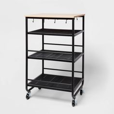 a black shelf with three shelves on wheels