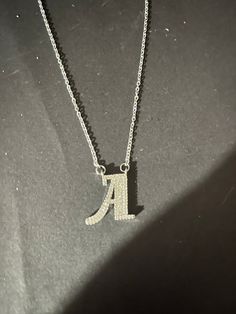 Silver necklace with the initial A charm with white rhinestones and extender. Silver Initial Pendant Clavicle Chain Necklace, Silver Letter Initial Necklace, Silver Initial Letter Charm Necklace, Silver Initial Pendant Necklace With Clavicle Chain, Initial A, Charm Necklaces, White Rhinestone, Initial Charm, Charm Pendant